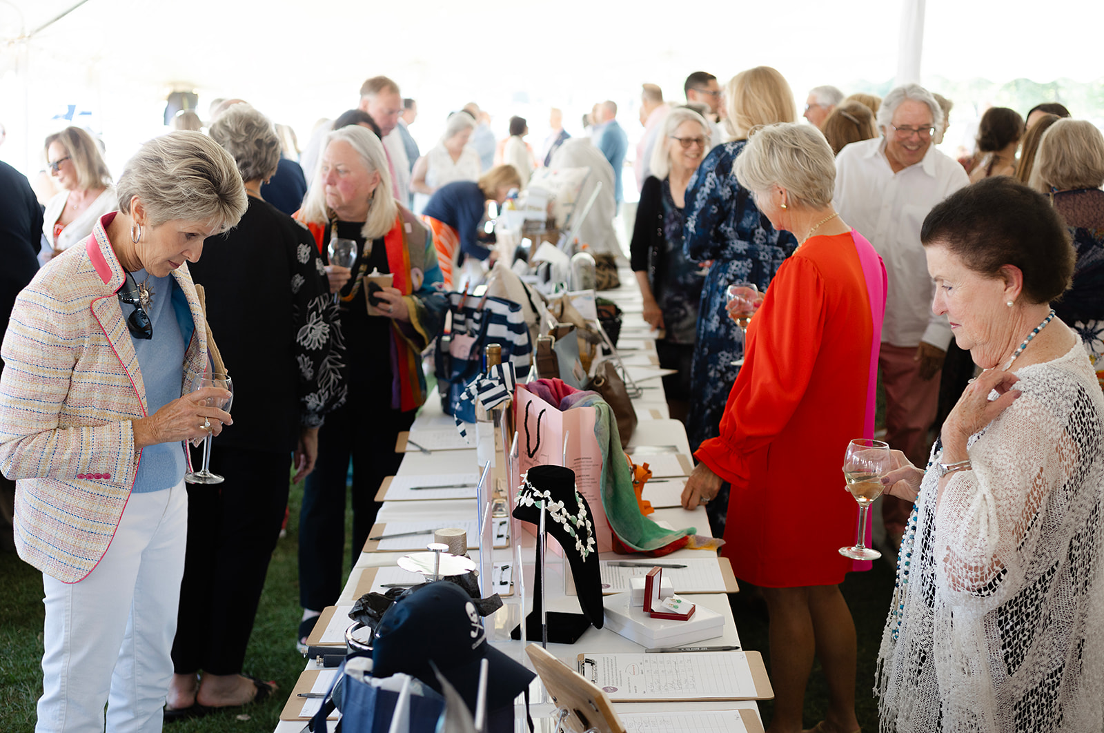 Attendees browsing the silent auction, with donations from 150 local businesses. Featuring Jane Hourani (left) and Carole Carroll, CTAC Board Member (right).