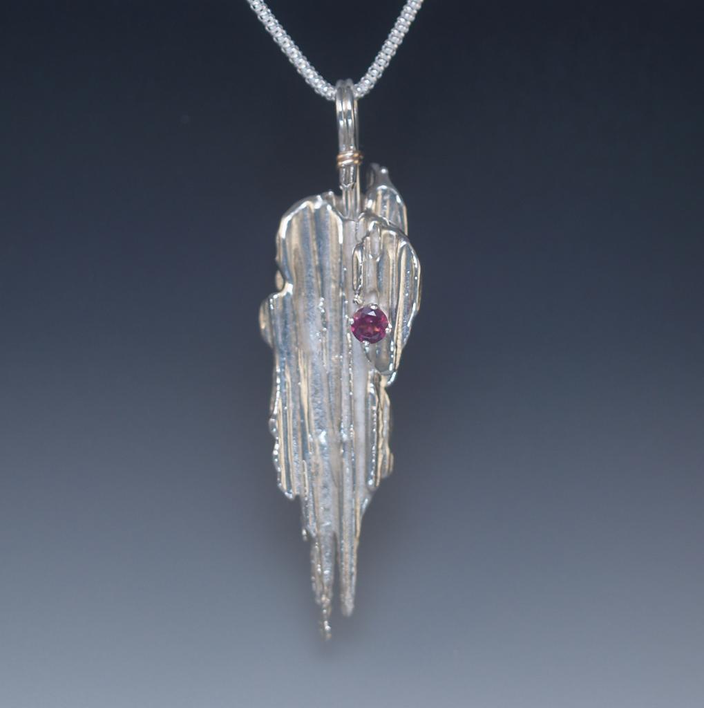 Silver broom cast pendant with Rhodolite garnet