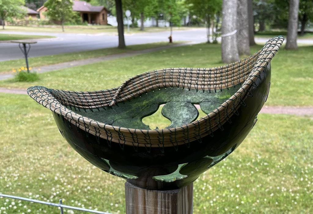 A large gourd basket, with ginkgo leaf cutouts and pine needle weaving.