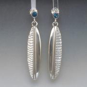 Silver cuttlebone cast earrings with blue topaz